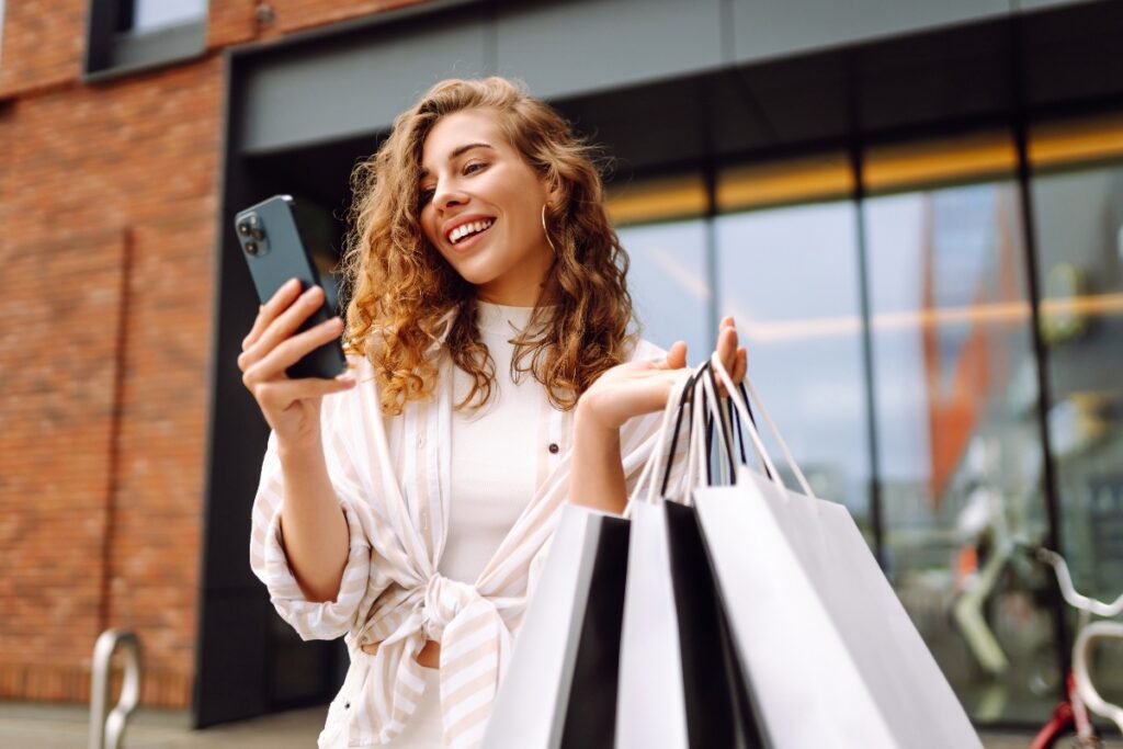 Ragazza impegnata negli acquisti del Black Friday controlla il cellulare.